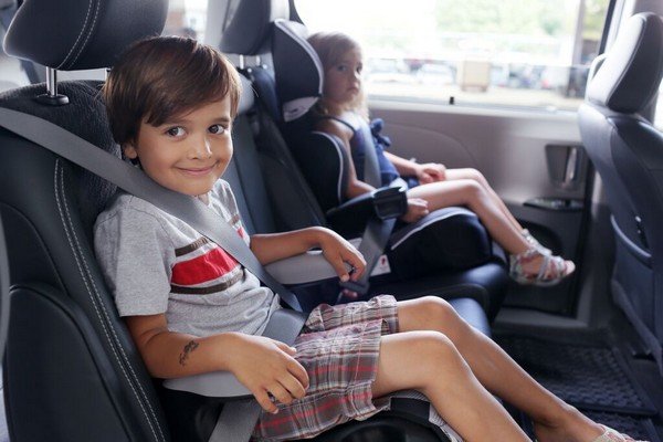 Children being secured with seatbelt in a car