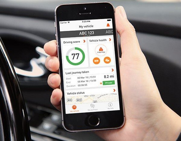  A telematics app for smartphone, smartphone held in hand
