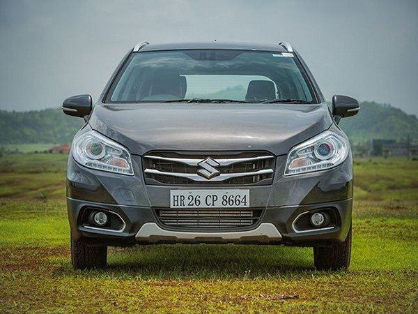 Maruti S-cross’ front view, on the meadow, mountainous background