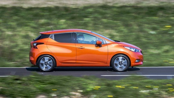 Orange 2018 Nissan Micra running on road, left side view