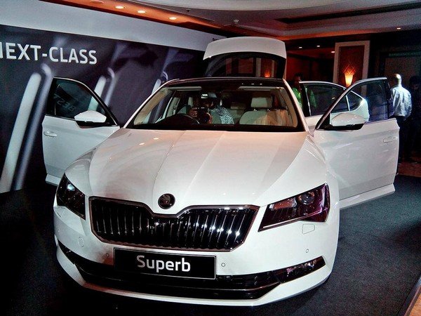 The Skoda Superb Corporate Edition white color at showroom door open