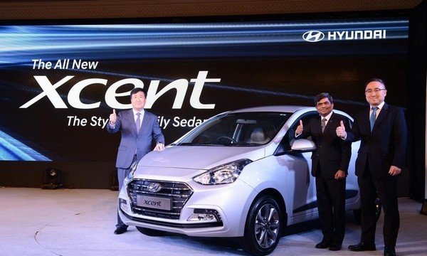Hyundai Xcent at showcase with 3 man