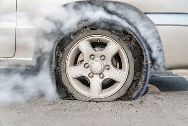 A tyre blows out with steam coming out of it