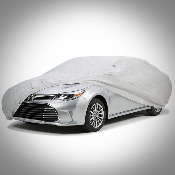  A grey car cover over a Toyota