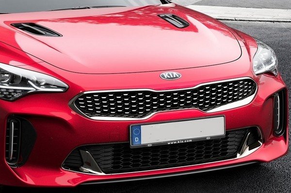 Kia car red color a cut zoom of capo and grill