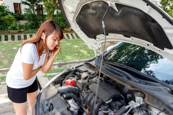 A girl wondering why her car usually keeps breaking down