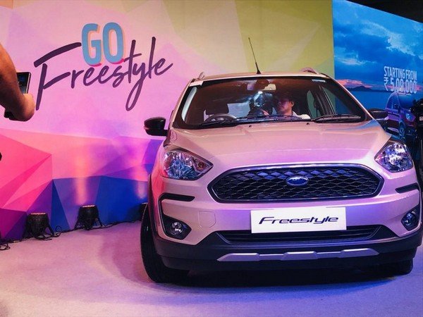 Ford Freestyle white color at showroom direct front look with man in cabin