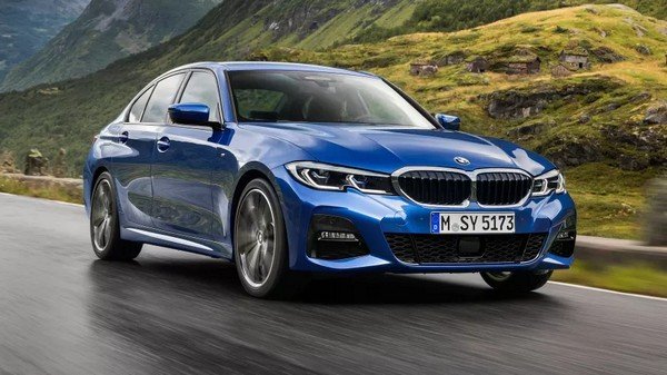 BMW 3 Series blue color front face running on road image 