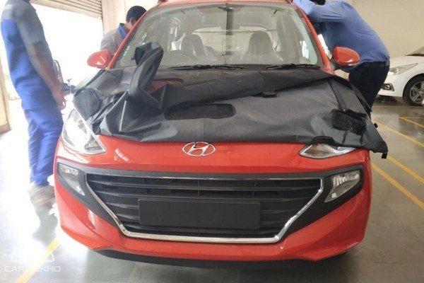 Hyundai Santro cover in mule in showroom before launch