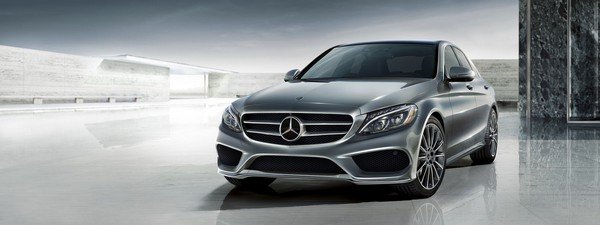 Mercesez car sedan from right to left silver color sky background 