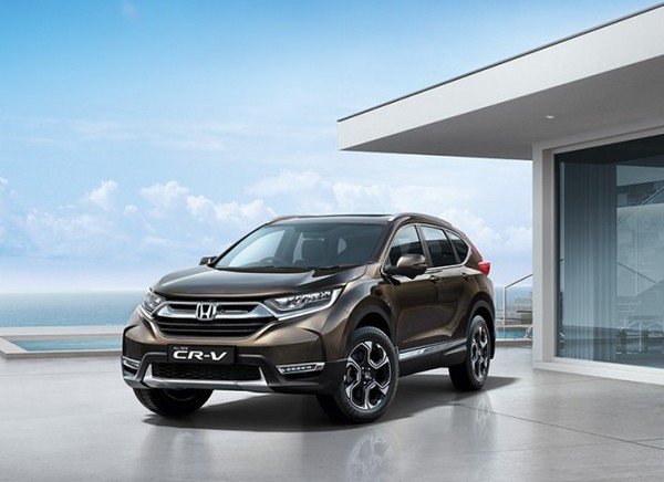 brown Honda CR-V angle front look out door background