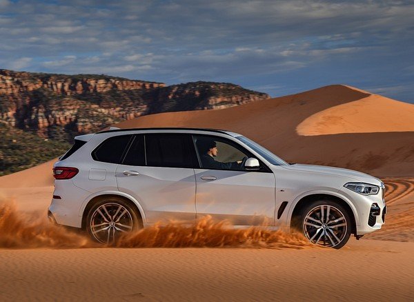 BMW X5 white color driving side look in desert