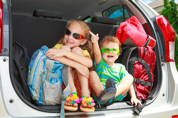kids are loading their stuff on car