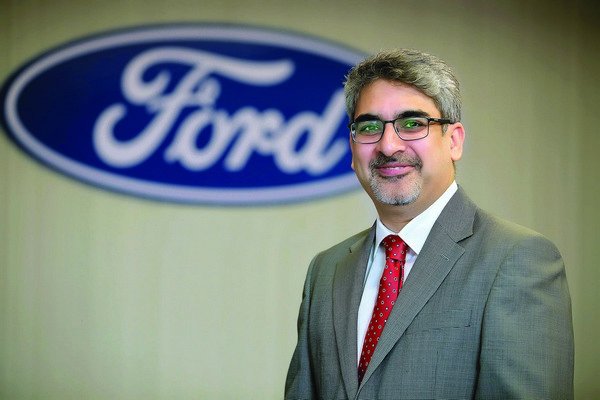 picture of Anurag Mehrotra in front of Ford logo