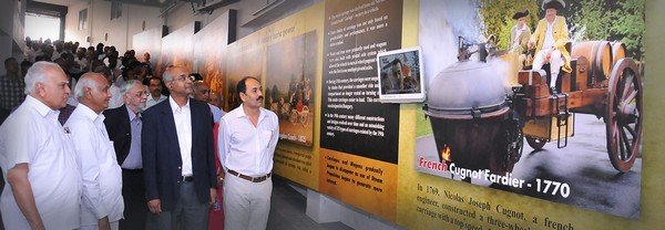 GeDee Car Museum people talking in front of pictures