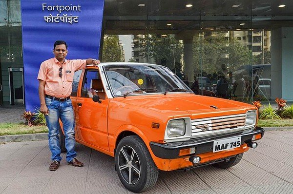 Vijay Potphode satnd with his orange finished classic Maruti