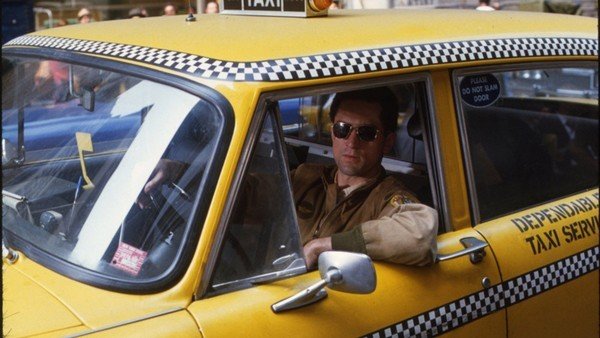 man sit inside yellow cab