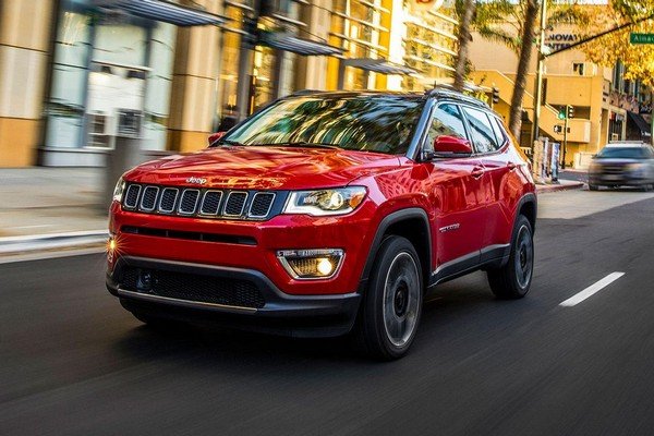 Jeep compass red color running on road