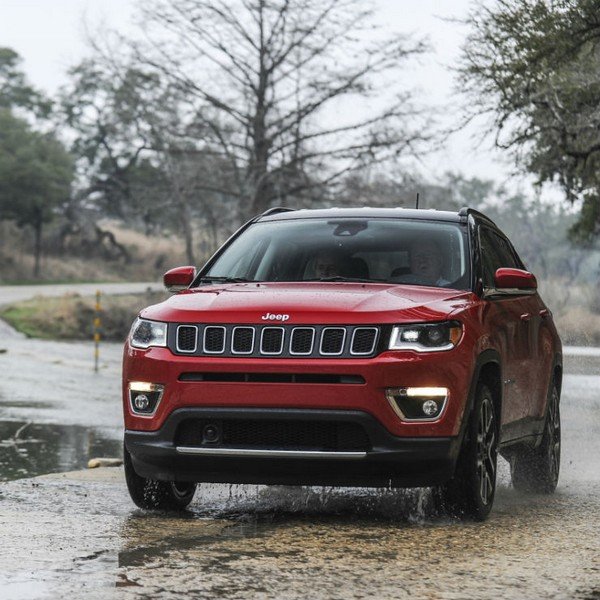 Jeep compass red color parking with tree background