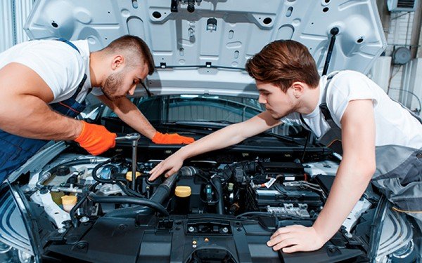 2 men fix car
