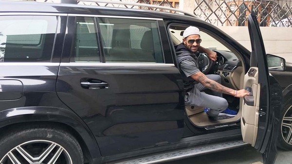 young shikhar dhawan getting out of his Mercedes-Benz GL350 CDI SUV