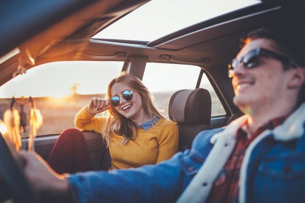 peole in car with sunroof in good weather