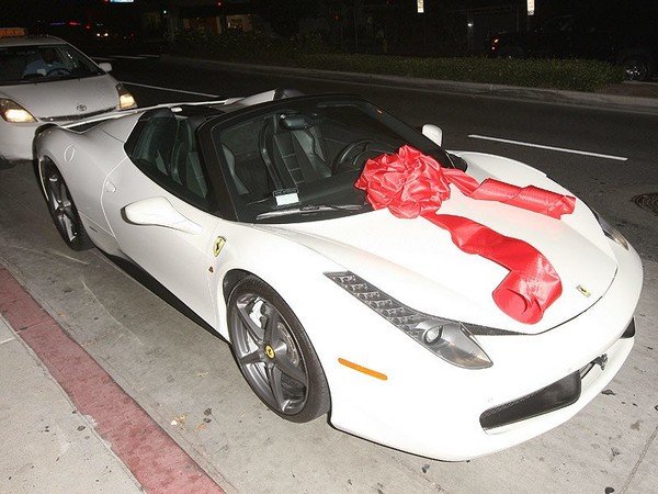 a white ferrari wrapped as a gift