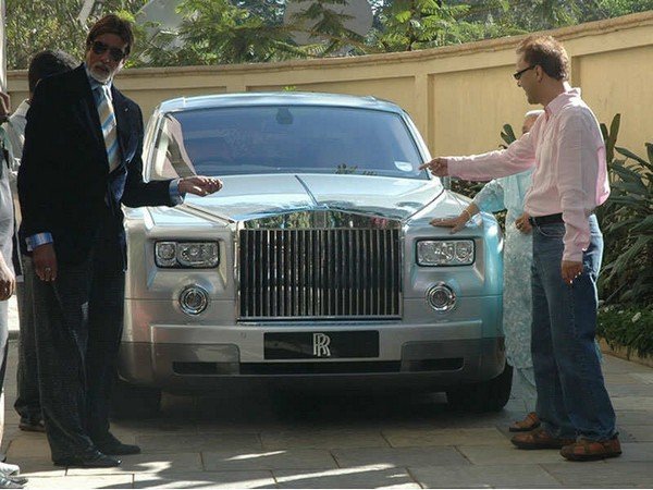 Amitabh Bachchan standing next to his rolls royce