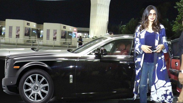 priyanka chopra standing in front of her rolls royce