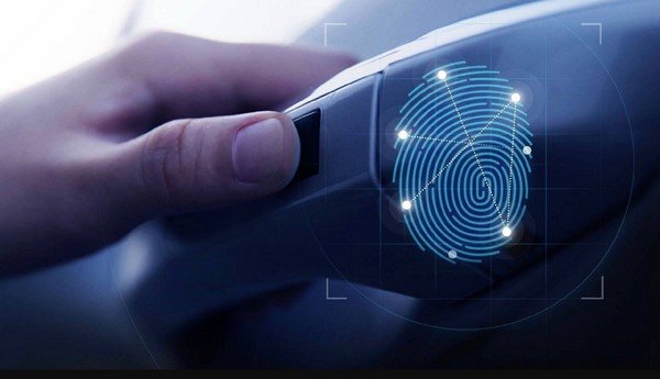 pressing hand on fingerprint sensor on car door handle