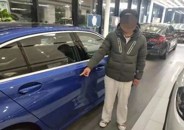 chinese man scratchhes bmw car