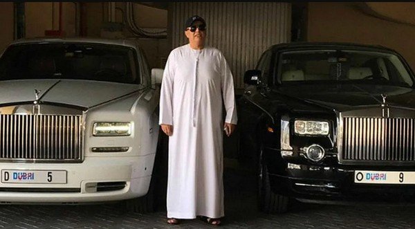 man among two rolls royce cars