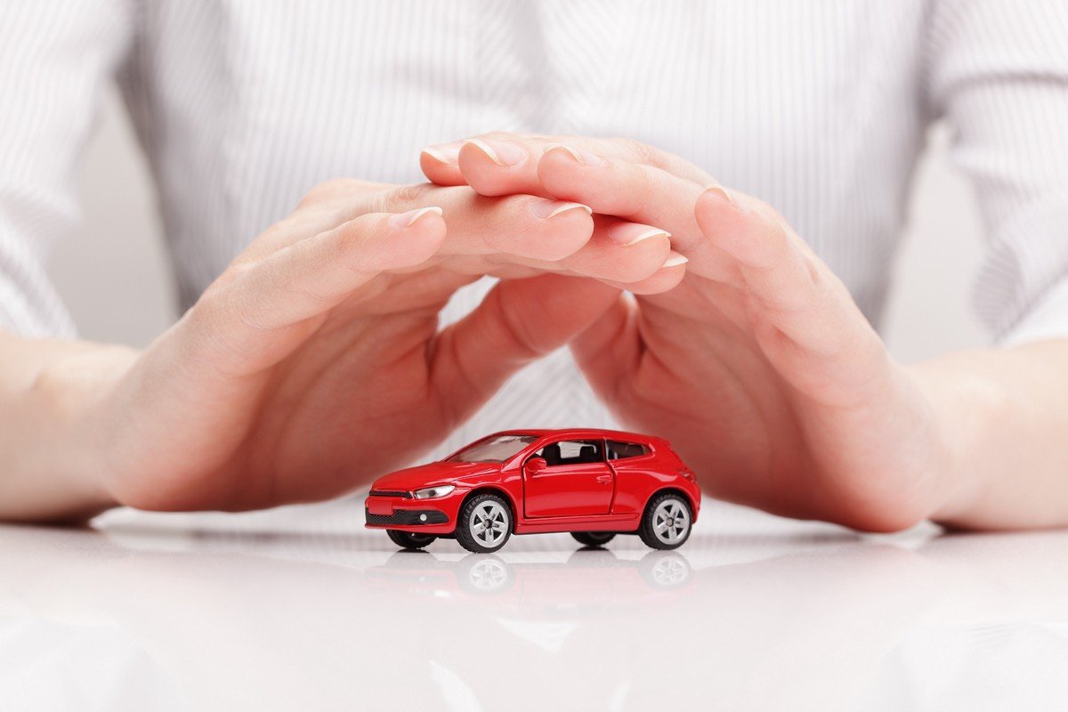 car insurance hand over a toy car