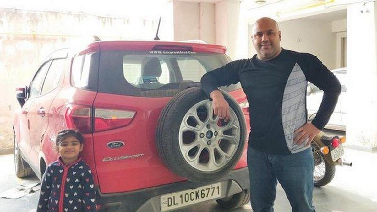 Vikas Shokeen, his red Ford EcoSport rear and a kid