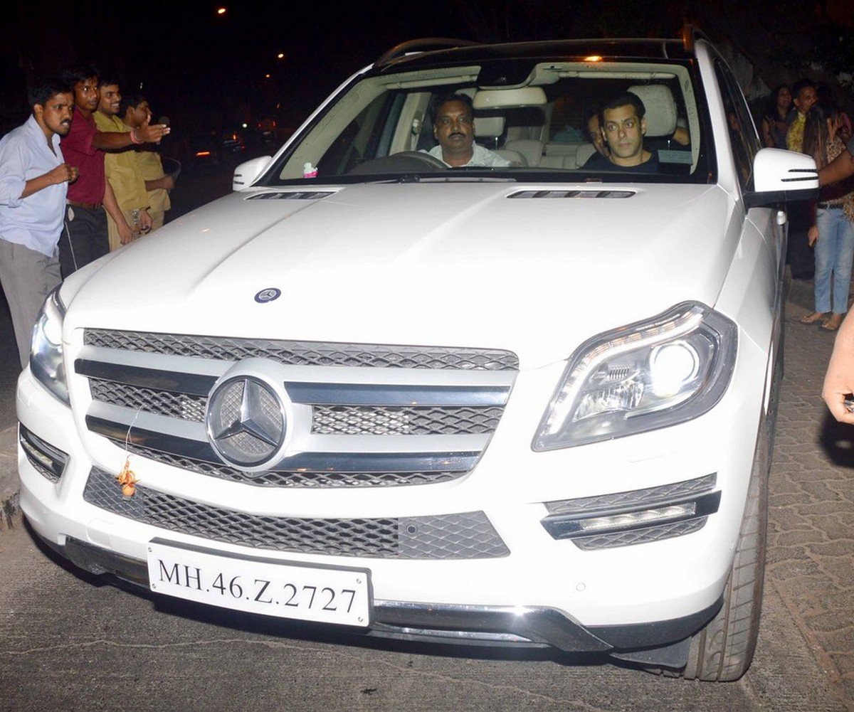 Salman Khan in the front passenger seat of his white Mercedes