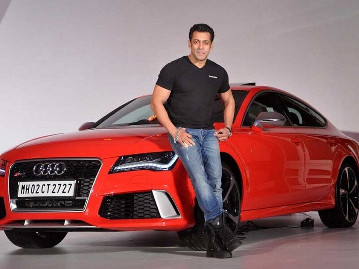 Salman Khan stands next to the red Audi RS7