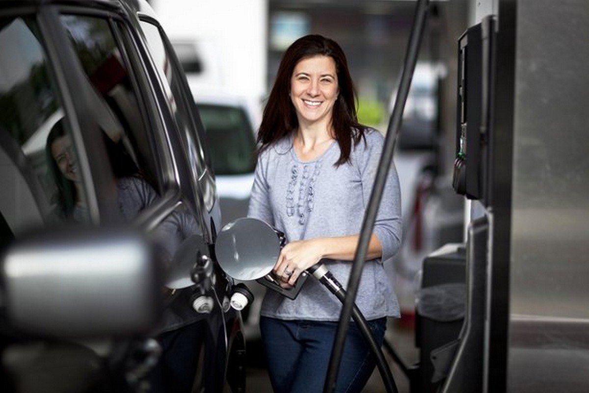 Woman filling gas