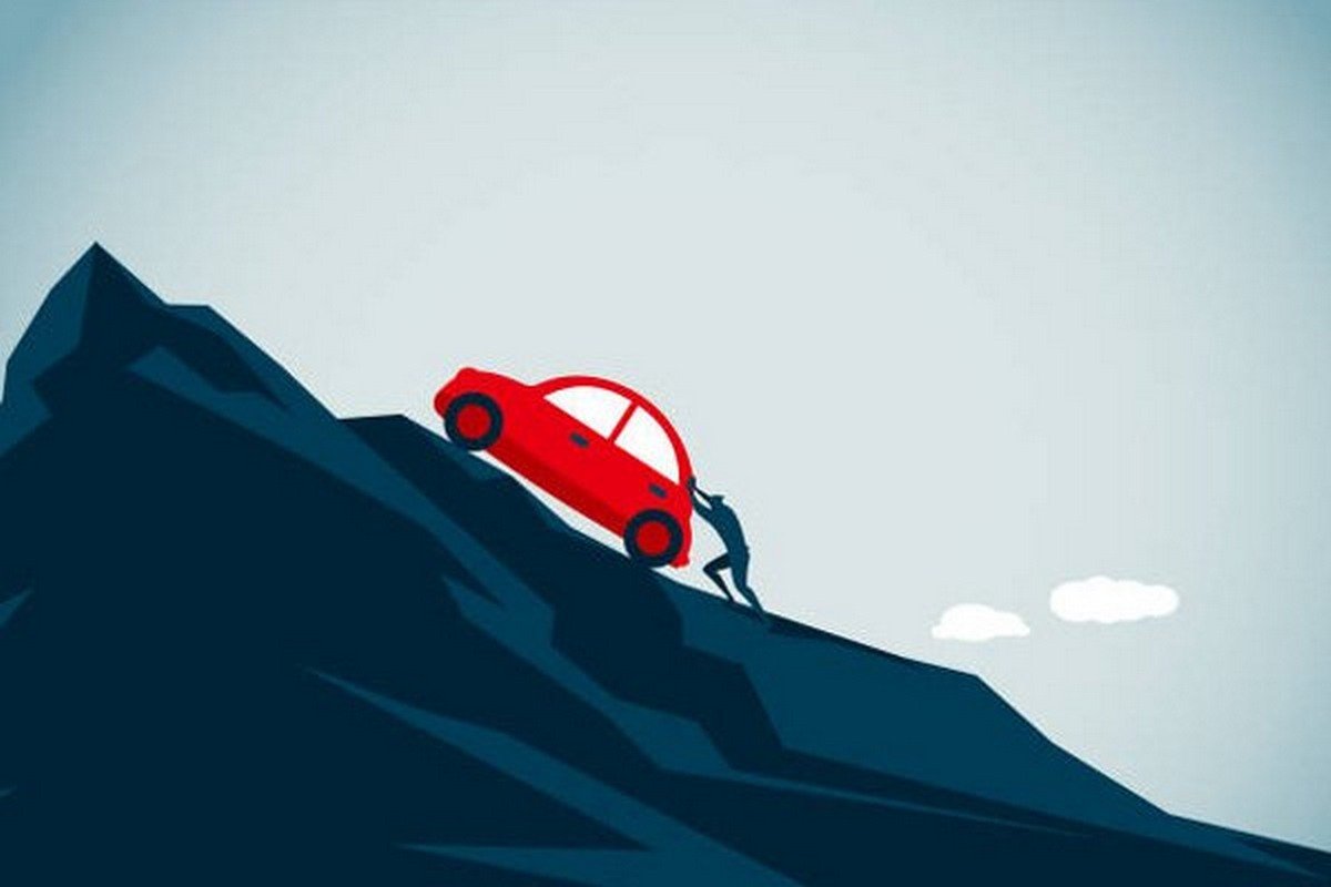illustration of a man pushing the car to the top of the mountain
