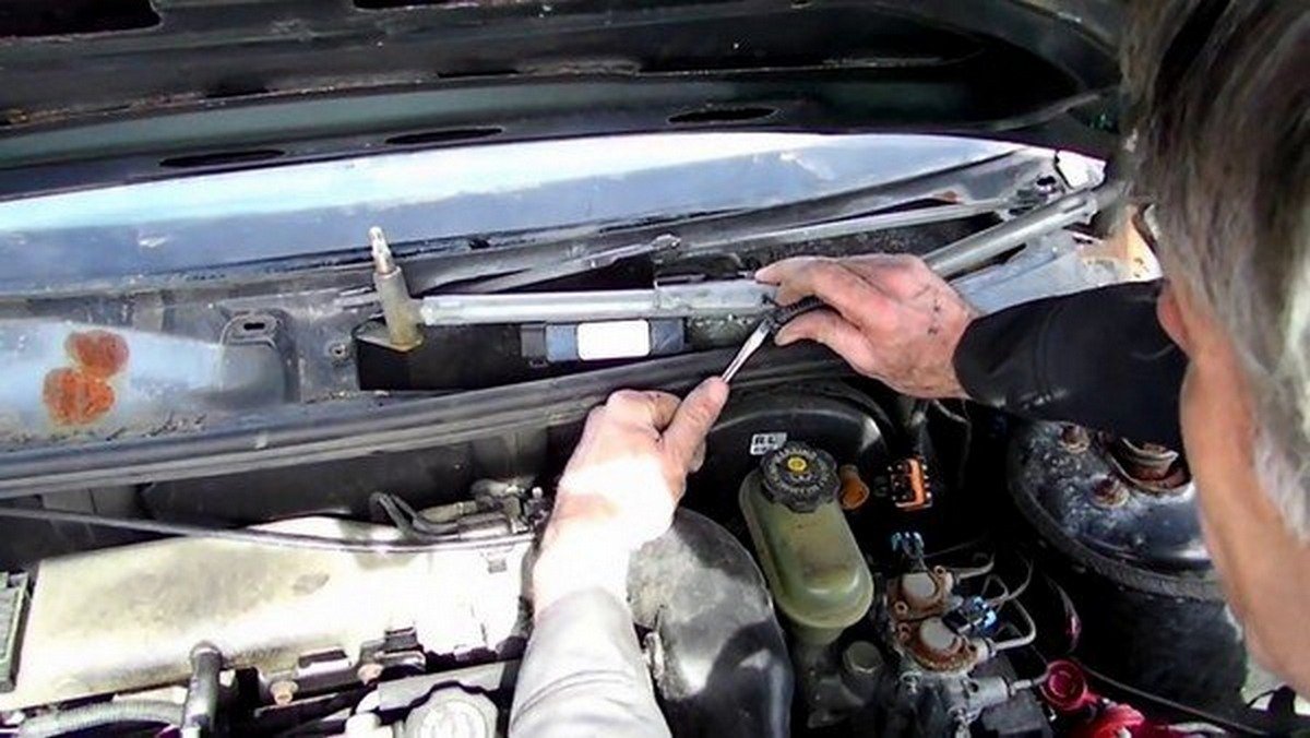 man fixing a malfunctioned wiper motor
