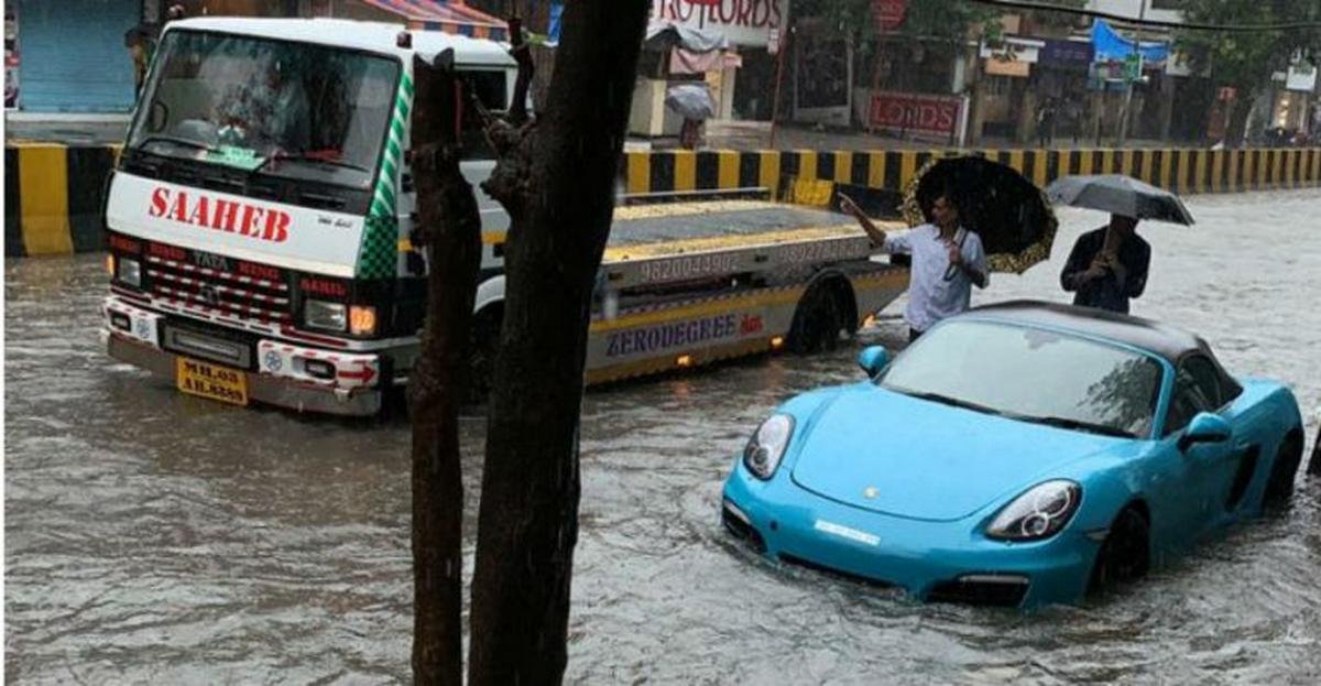 Porsche boxster blue stuck in flood