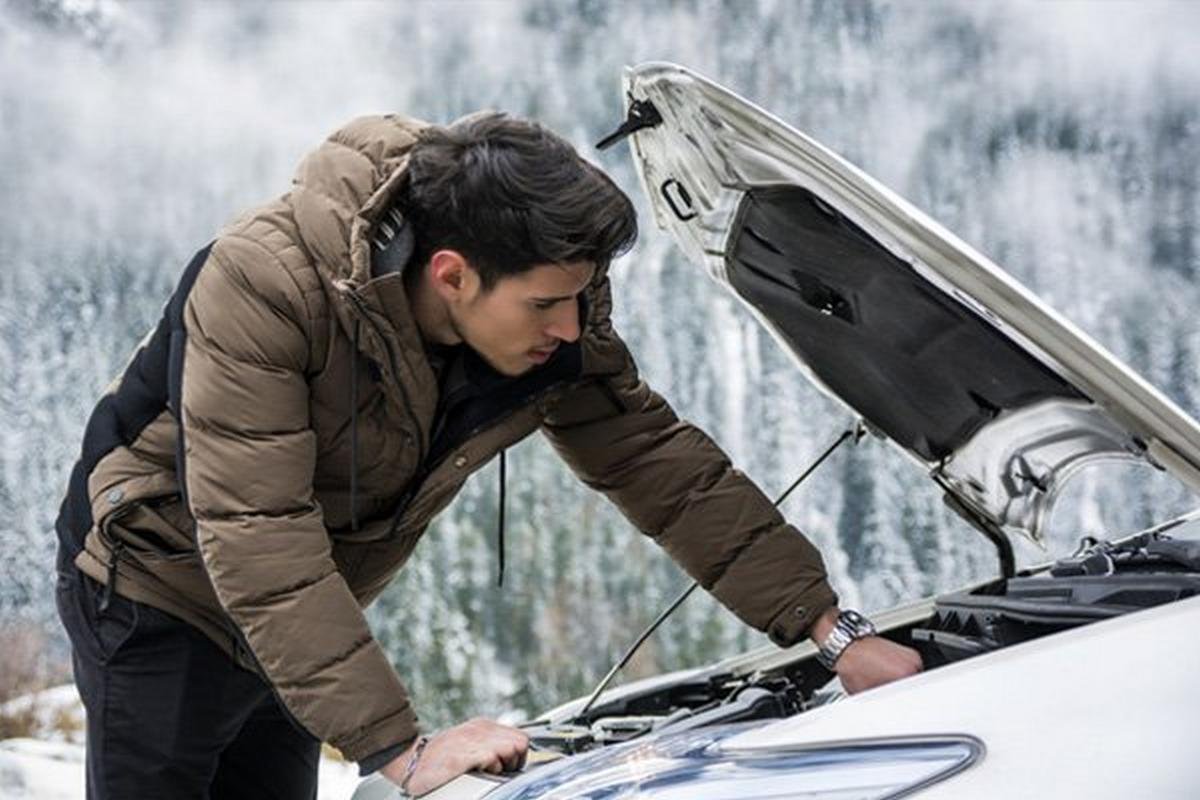 a man is fixing his car