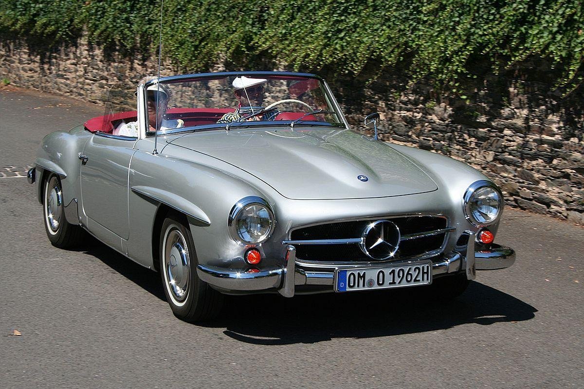 man driving silver Mercedes-Benz 190 SL