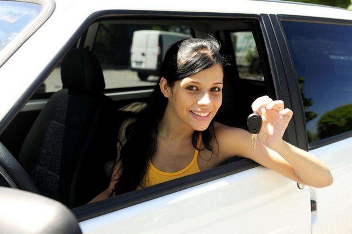 teen girls holding a key in a car