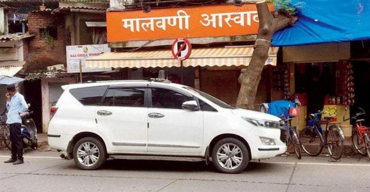 white toyota innova parking on road