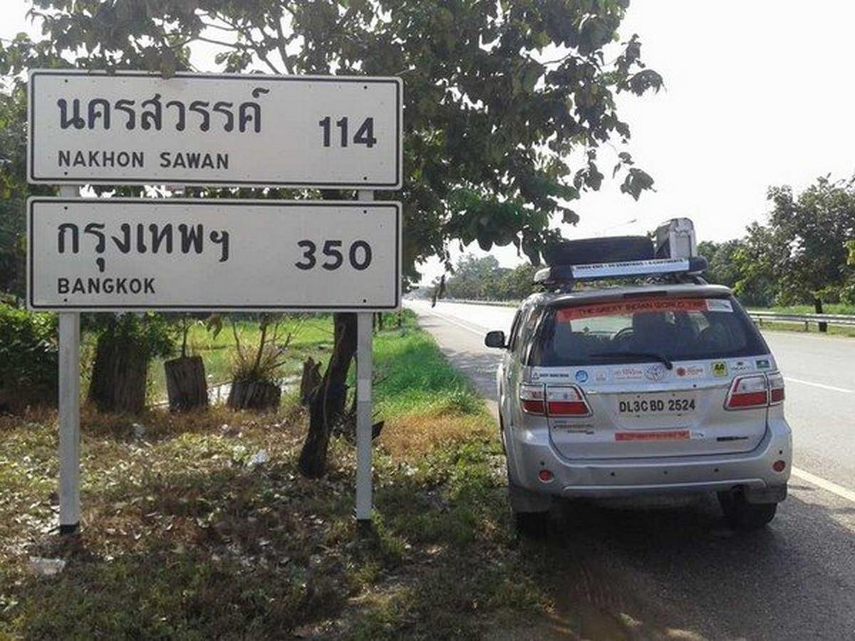 a car on the right of the road signs