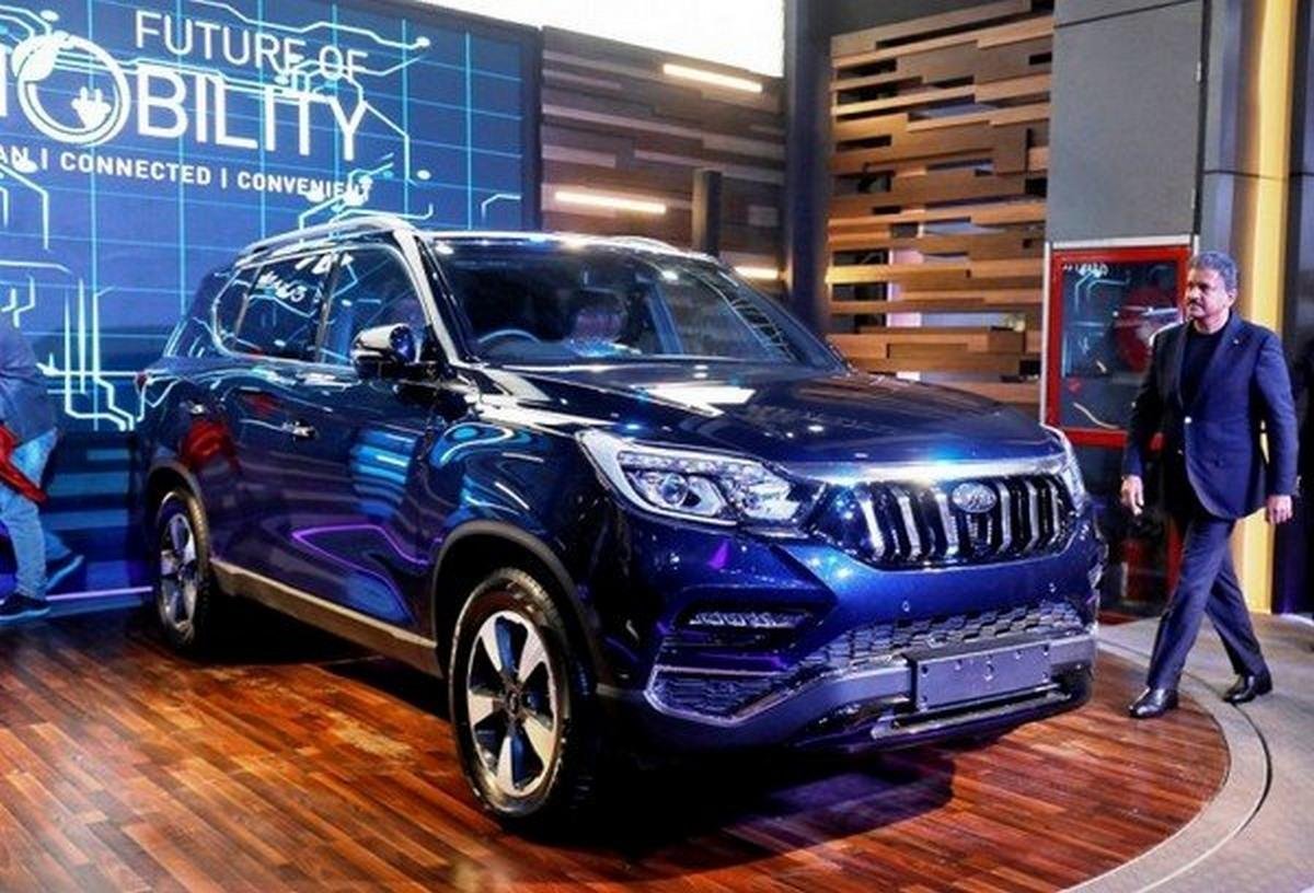 Mahindra Alturas G4 at showroom with a man