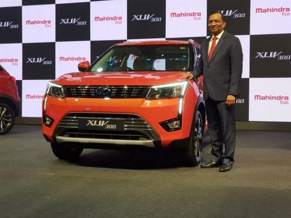 Mahindra XUV300 orange color at showroom with one man