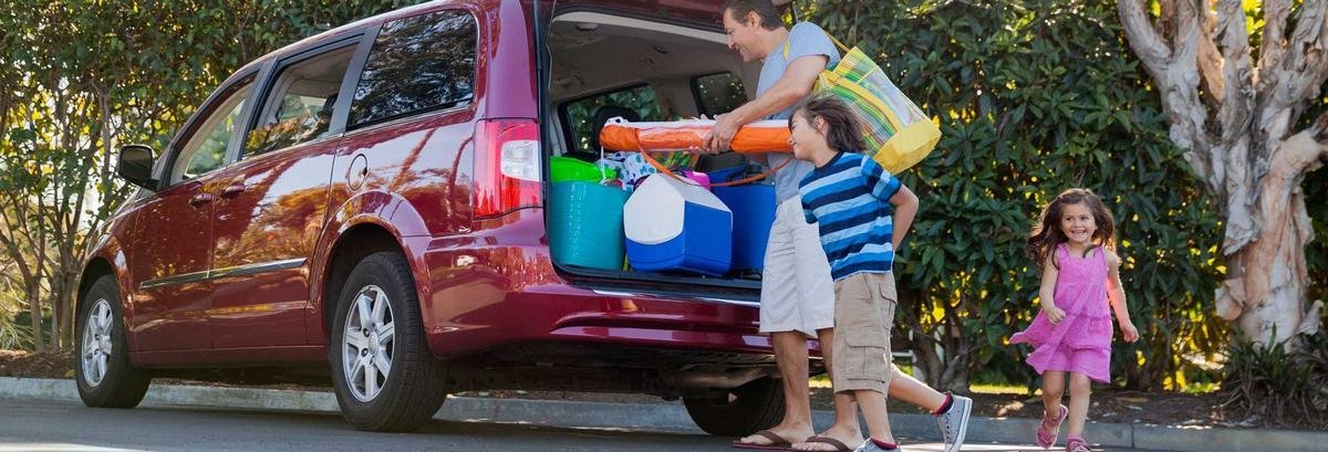 family sitting a car