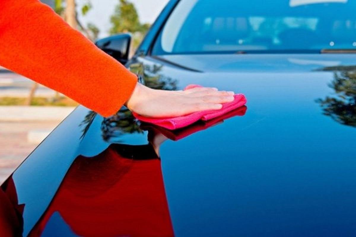 a woman cleans a car