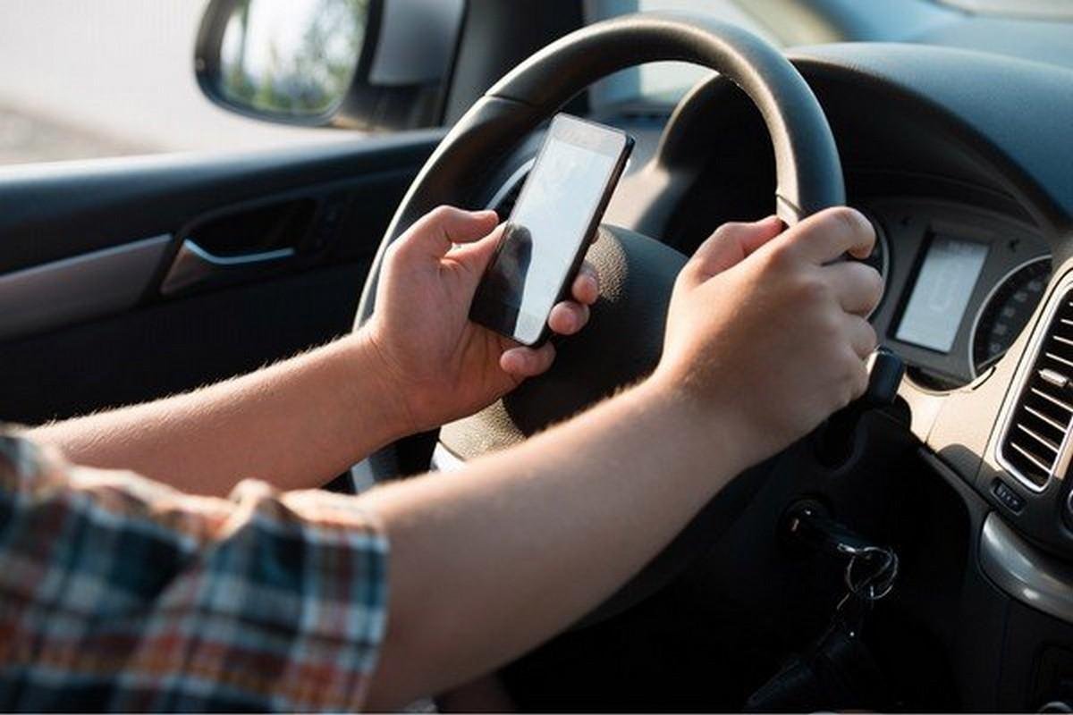 using phones while driving with two hands on the steering wheel 